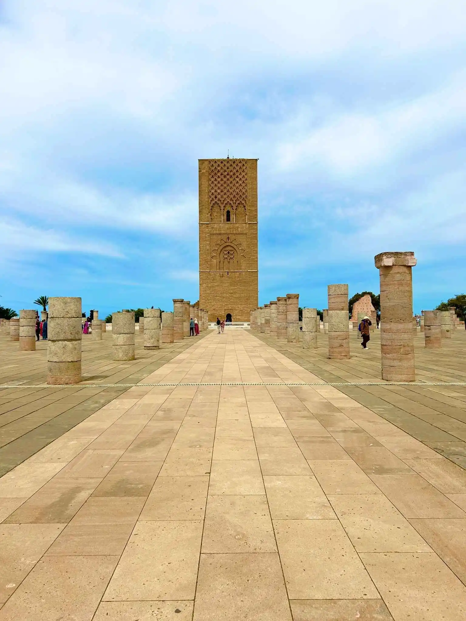 Hassan Tower promenade (Rabat). Central walkway through rows of ruined columns leading to the iconic unfinished minaret—and a secure experience for tourists exploring Morocco’s vibrant capital.