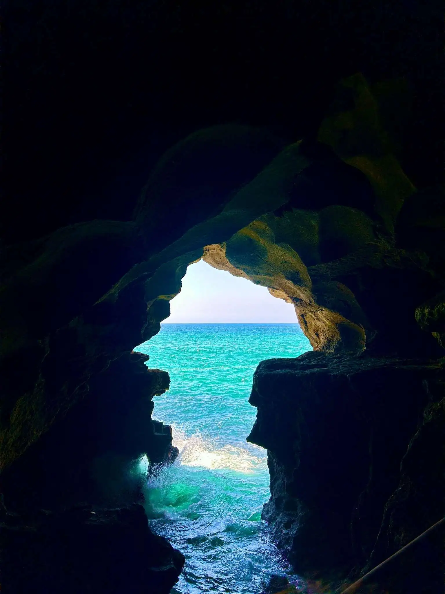 Cave of Hercules, Tangier: Turquoise Atlantic surf glows through the cave opening shaped like the map of Africa. Access paths and attentive attendants make the viewpoint straightforward and reassuring for first-time visitors.